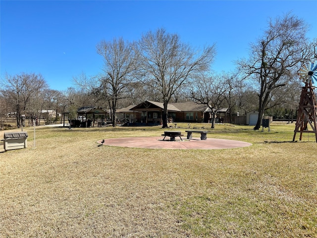 exterior space featuring a gazebo, a patio area, and an outdoor structure