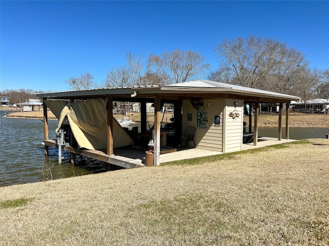 dock area featuring a yard, a water view, and boat lift