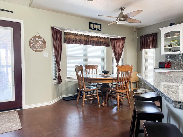 20315 Post Oak Loop, Thornton, TX 76687 - dining space with baseboards, a ceiling fan, finished concrete floors, and a healthy amount of sunlight
