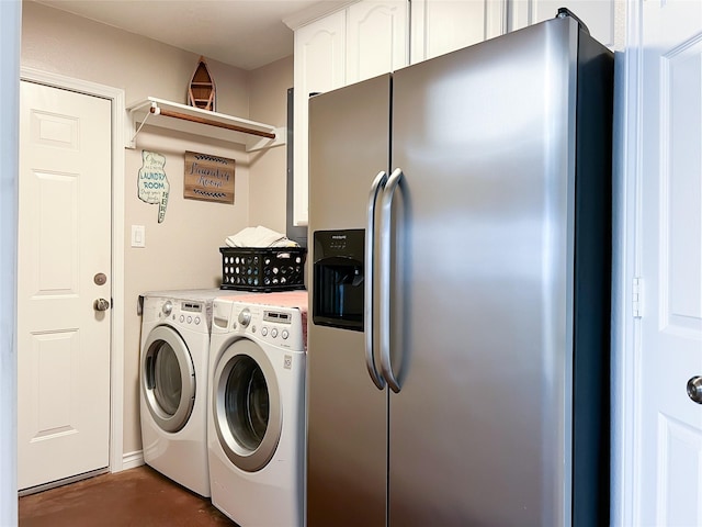 clothes washing area featuring cabinet space and washing machine and dryer