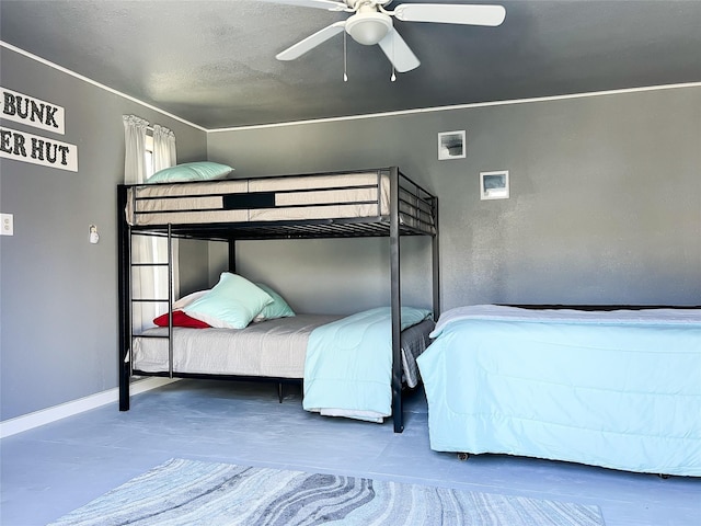 unfurnished bedroom featuring a textured ceiling, finished concrete flooring, baseboards, and ceiling fan