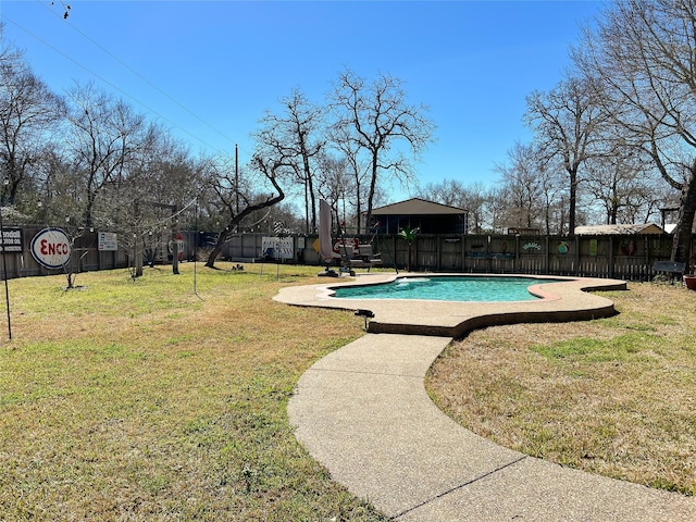 view of swimming pool with a lawn, a fenced in pool, and fence