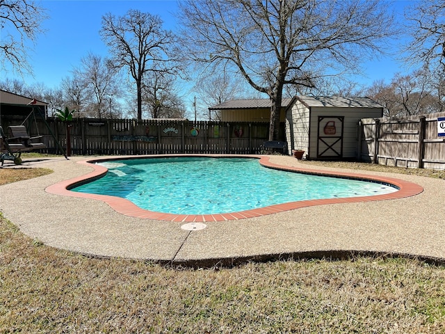 view of swimming pool featuring an outdoor structure, a storage unit, a fenced backyard, and a fenced in pool