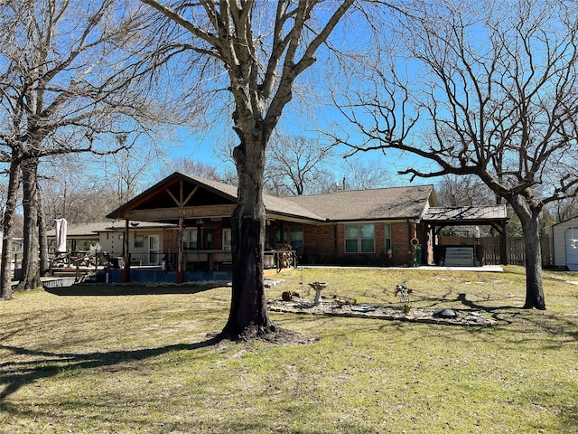 rear view of house with a yard and brick siding