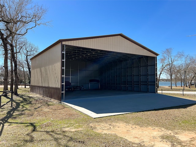 view of pole building featuring a detached carport and dirt driveway