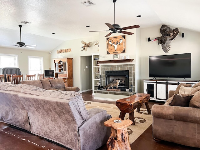 living area featuring visible vents, ceiling fan, and lofted ceiling