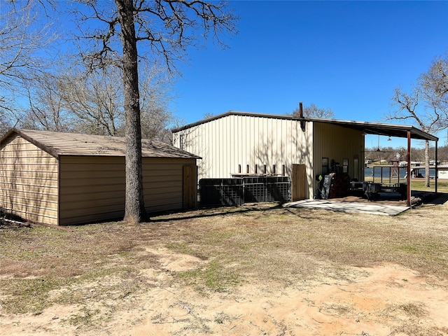 view of property exterior with an outdoor structure and a pole building