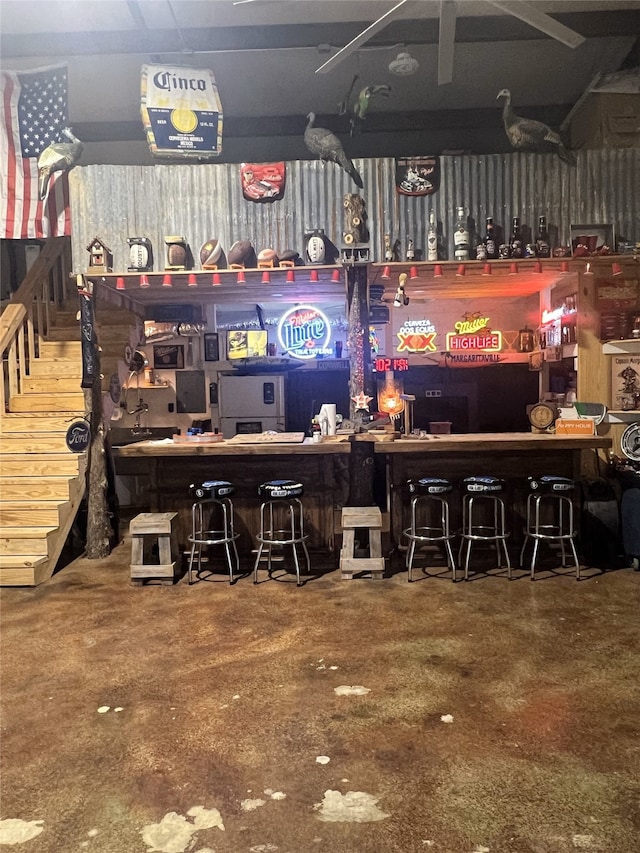20315 Post Oak Loop, Thornton, TX 76687 - bar featuring concrete floors, a workshop area, a bar, and stairs