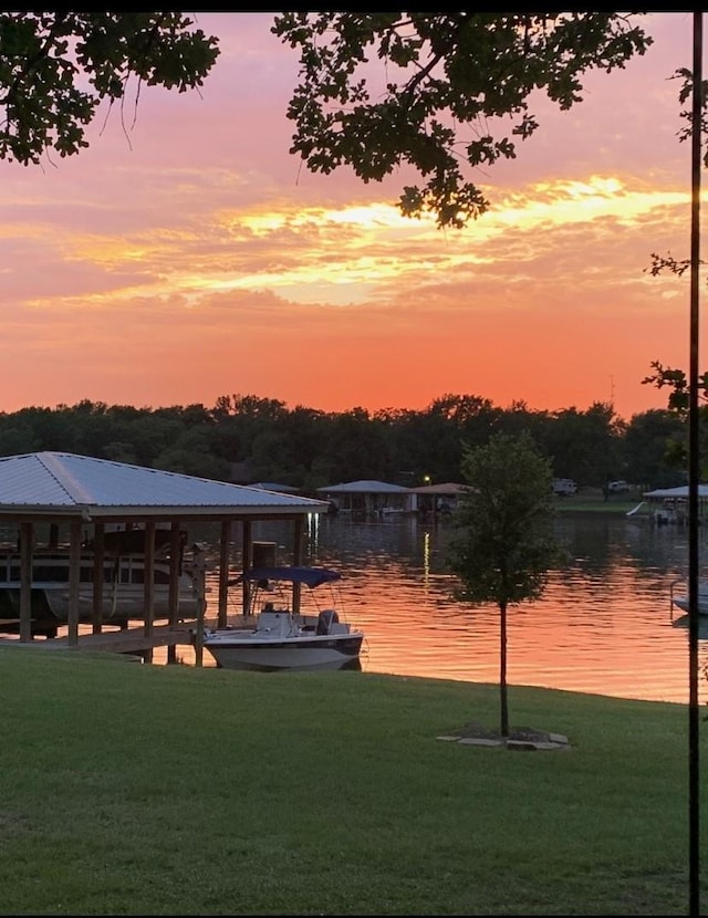 dock area featuring a yard and a water view