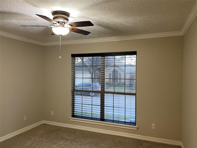 spare room featuring a textured ceiling, ornamental molding, carpet, and ceiling fan