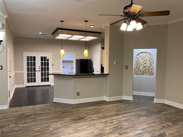 kitchen featuring dark countertops, black refrigerator, crown molding, french doors, and dark wood-style floors