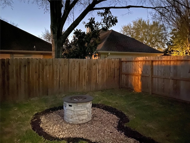 view of yard with a fenced backyard and an outdoor fire pit