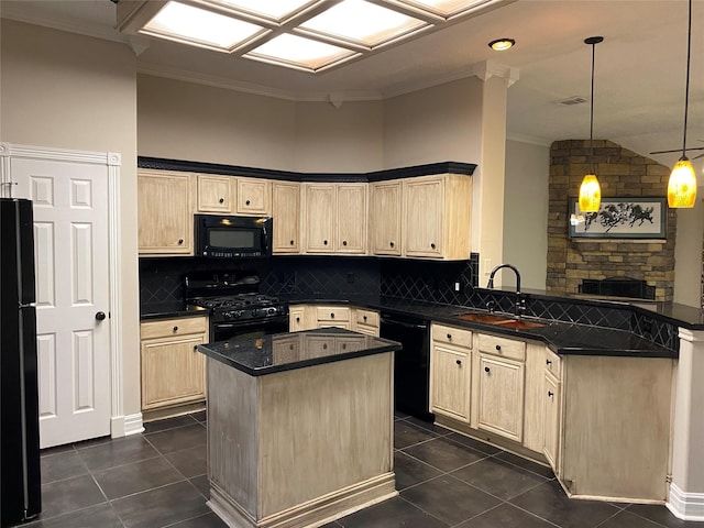 kitchen featuring black appliances, dark tile patterned floors, light brown cabinetry, a sink, and a peninsula