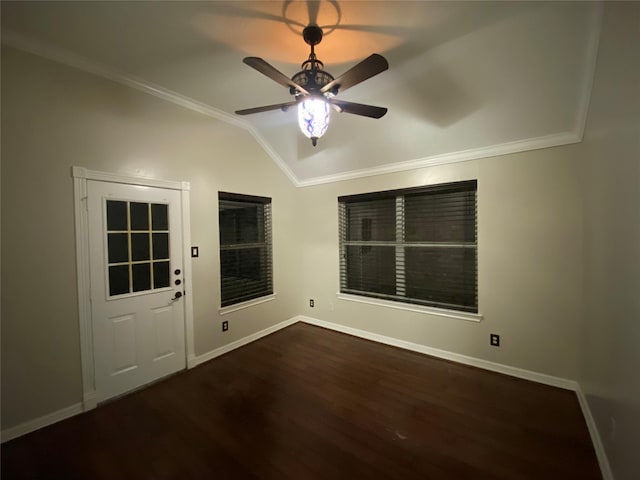 unfurnished room featuring baseboards, ornamental molding, vaulted ceiling, wood finished floors, and a ceiling fan