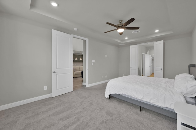 bedroom featuring baseboards, visible vents, a raised ceiling, carpet, and recessed lighting