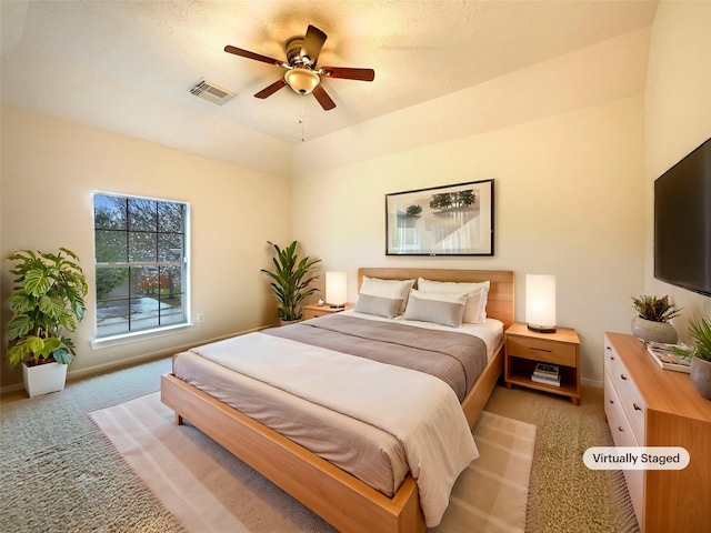 bedroom with baseboards, a ceiling fan, visible vents, and light colored carpet