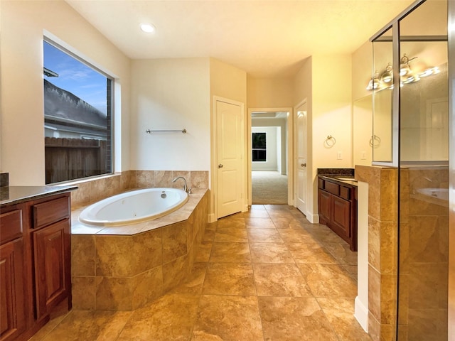 bathroom featuring vanity and a bath