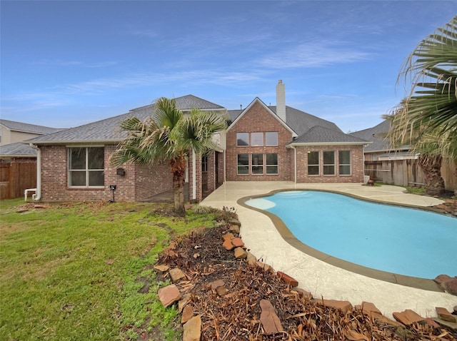 view of swimming pool featuring a patio, a lawn, a fenced backyard, and a fenced in pool