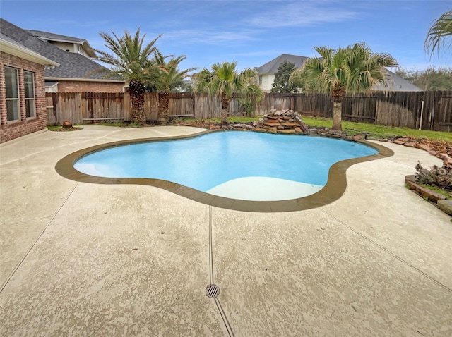 view of pool featuring a patio, a fenced backyard, and a fenced in pool