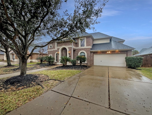 view of front of home featuring concrete driveway, brick siding, an attached garage, and a shingled roof