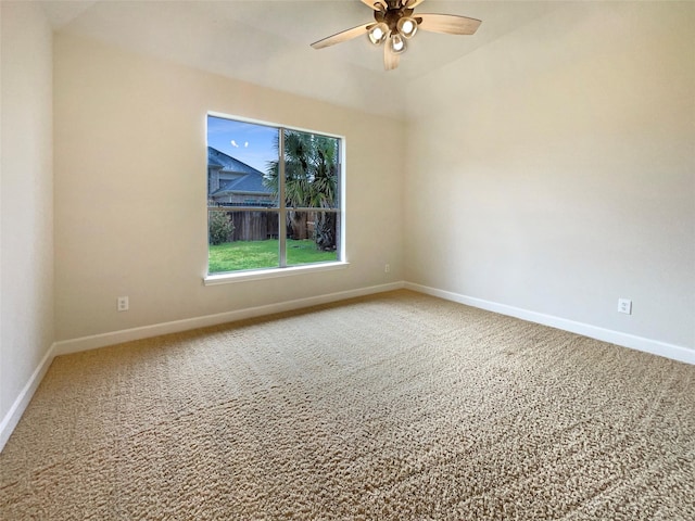 spare room with carpet, baseboards, and a ceiling fan