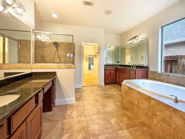 full bathroom featuring visible vents, a sink, tile patterned flooring, tiled shower, and a bath