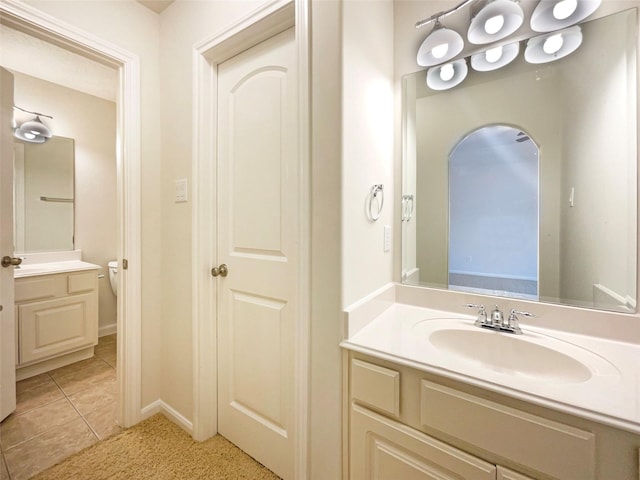 bathroom with vanity, baseboards, and tile patterned floors