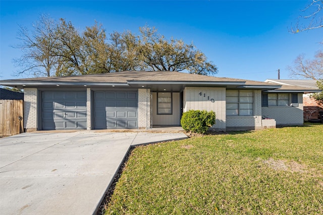 mid-century inspired home featuring a garage, brick siding, driveway, and a front yard