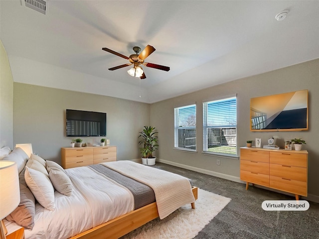 bedroom featuring a ceiling fan, dark colored carpet, visible vents, and baseboards