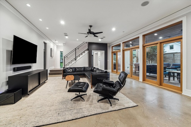 living area featuring finished concrete floors, recessed lighting, french doors, and stairs