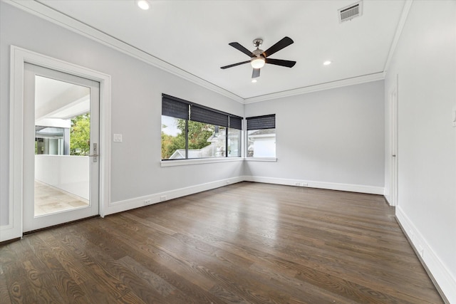 spare room featuring baseboards, visible vents, dark wood finished floors, ornamental molding, and recessed lighting