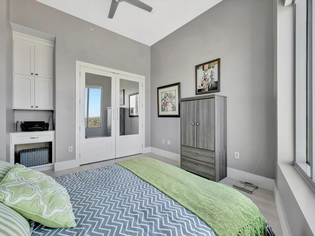 bedroom with baseboards, a ceiling fan, and french doors