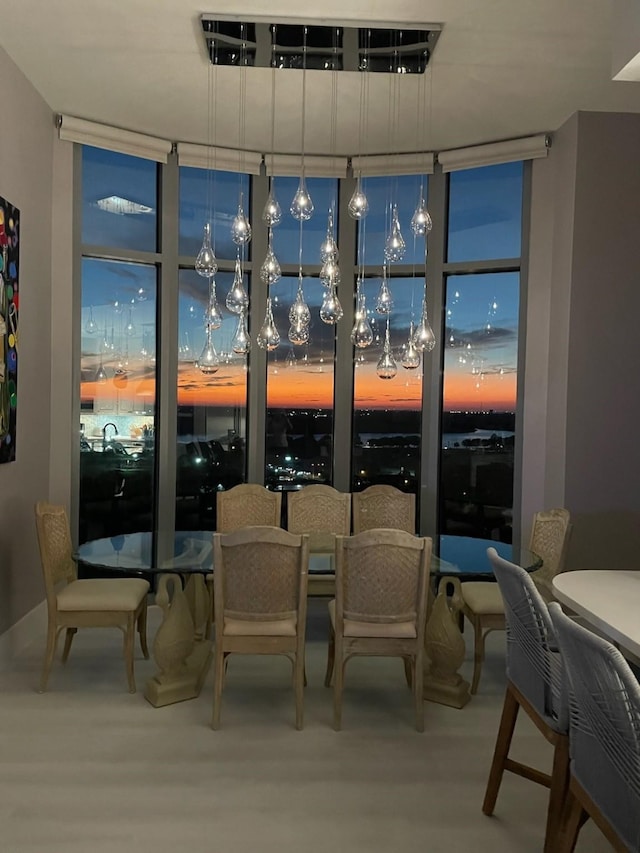 dining area featuring expansive windows and wood finished floors