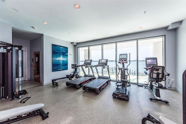 exercise room with recessed lighting and baseboards