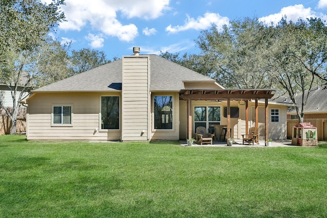 back of house featuring a yard, a patio, a chimney, and fence