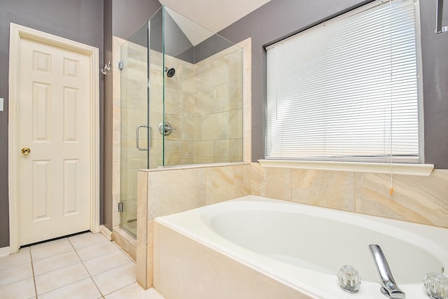 full bathroom with a stall shower, a bath, and tile patterned floors