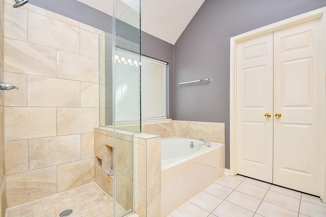 full bathroom with a garden tub, vaulted ceiling, tiled shower, and tile patterned floors