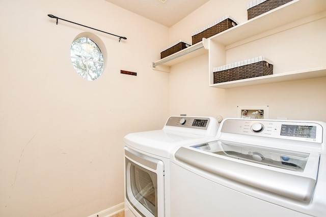 laundry area featuring laundry area, baseboards, and washing machine and clothes dryer