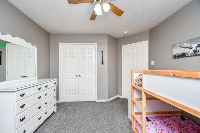 carpeted bedroom with a closet, ceiling fan, and baseboards