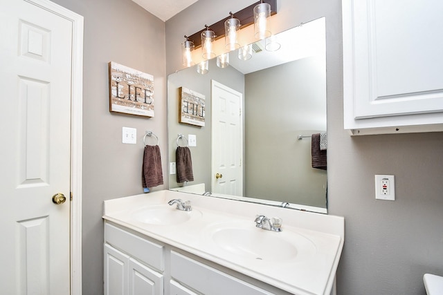 bathroom featuring double vanity and a sink