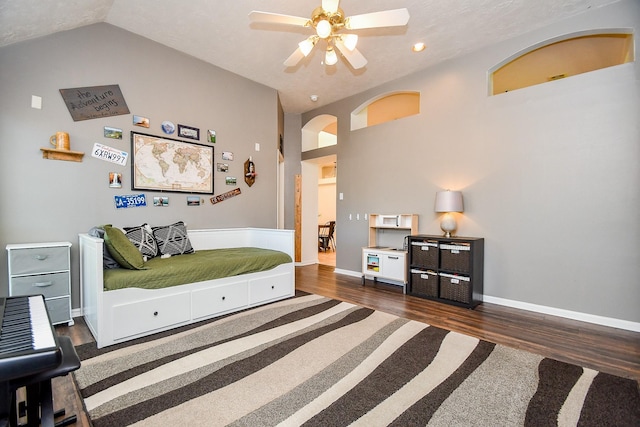 bedroom featuring arched walkways, ceiling fan, vaulted ceiling, wood finished floors, and baseboards