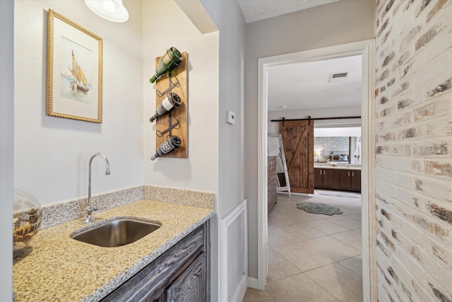 bathroom featuring visible vents, vanity, a textured ceiling, and tile patterned floors