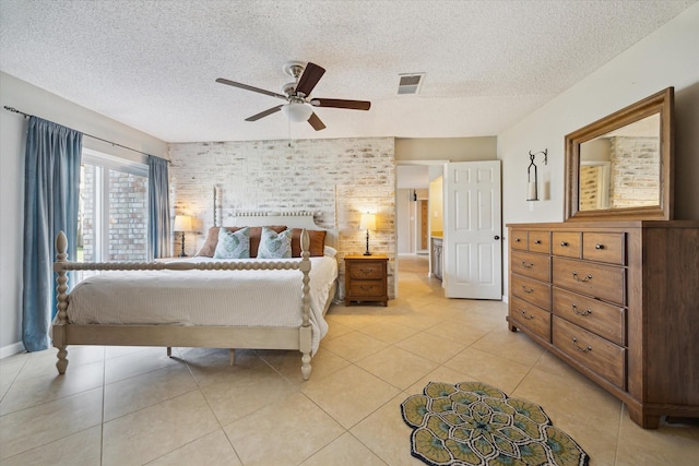 bedroom with a ceiling fan, visible vents, a textured ceiling, and light tile patterned floors