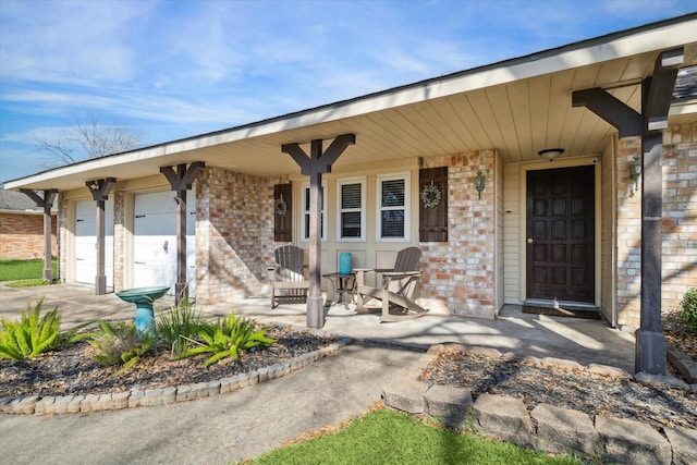 property entrance featuring covered porch and brick siding