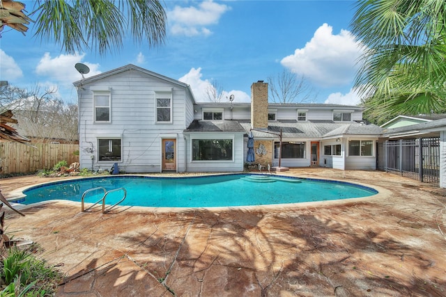 view of swimming pool featuring a fenced in pool, a patio, and fence