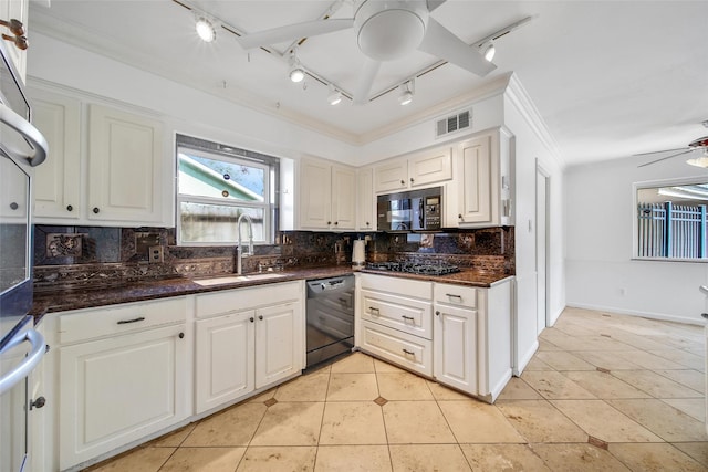 kitchen featuring visible vents, black appliances, decorative backsplash, and a sink