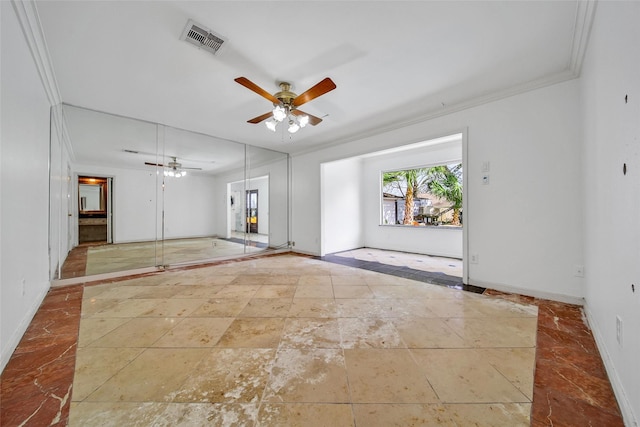 unfurnished room featuring visible vents, a ceiling fan, baseboards, and ornamental molding