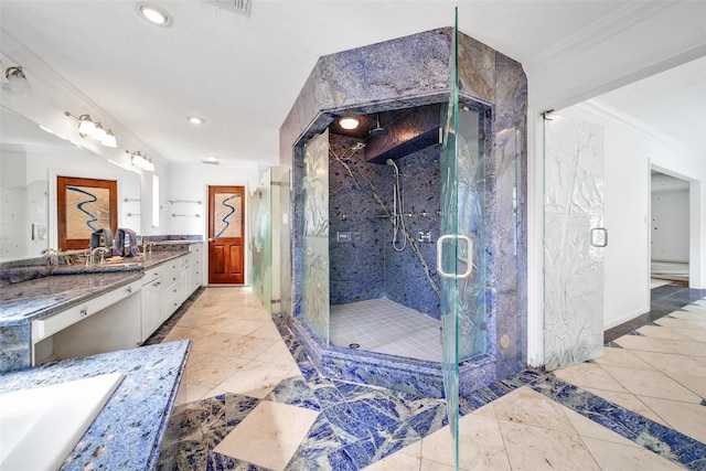 bathroom with a marble finish shower, tile patterned floors, vanity, and crown molding