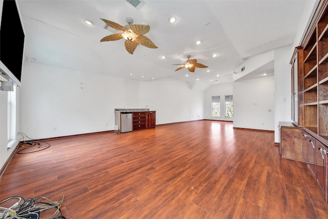 unfurnished living room with visible vents, wood finished floors, recessed lighting, baseboards, and lofted ceiling