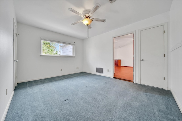 unfurnished bedroom with visible vents, a ceiling fan, ensuite bath, carpet, and baseboards